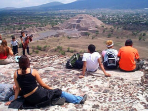 Tourists sit atop the Pyramid of the Moon in Teotihuacan to contemplate the majestic Pyramid of the Sun. This archeological zone is located outside Mexico City. © Rick Meyer, 2001