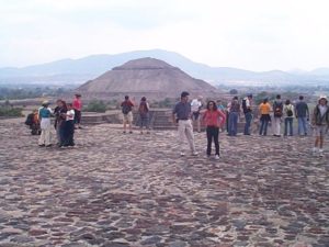 From the plaza part way up the pyramid of the moon, the pyramid of the sun appears to take on the shape of the distant hill.