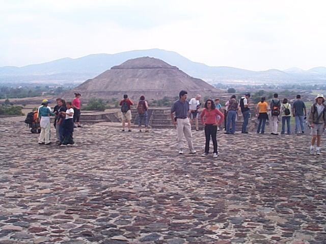 From the plaza part way up the pyramid of the moon, the pyramid of the sun appears to take on the shape of the distant hill.