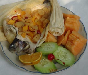 Trout with tropical fruit wrapped in corn husks © Karen Hursh Graber, 2013