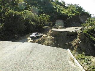 This road, graded to a high standard for gravel-based bituminous construction, was less than one year old when it washed out. Fortunately, there was still enough mountainside left to make a bypass. Many, in more remote areas of Oaxaca, whose roads were dirt, are walking in and out on goatpaths, after the recent earthquake and floods. © Dan McWethy, 1999