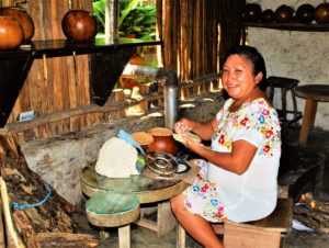 Making tortillas by hand, a cook pats chunks of masa into wafer thin, perfectly round circles which she then cooks on a wood burning comal. © 2020 Jane Ammeson