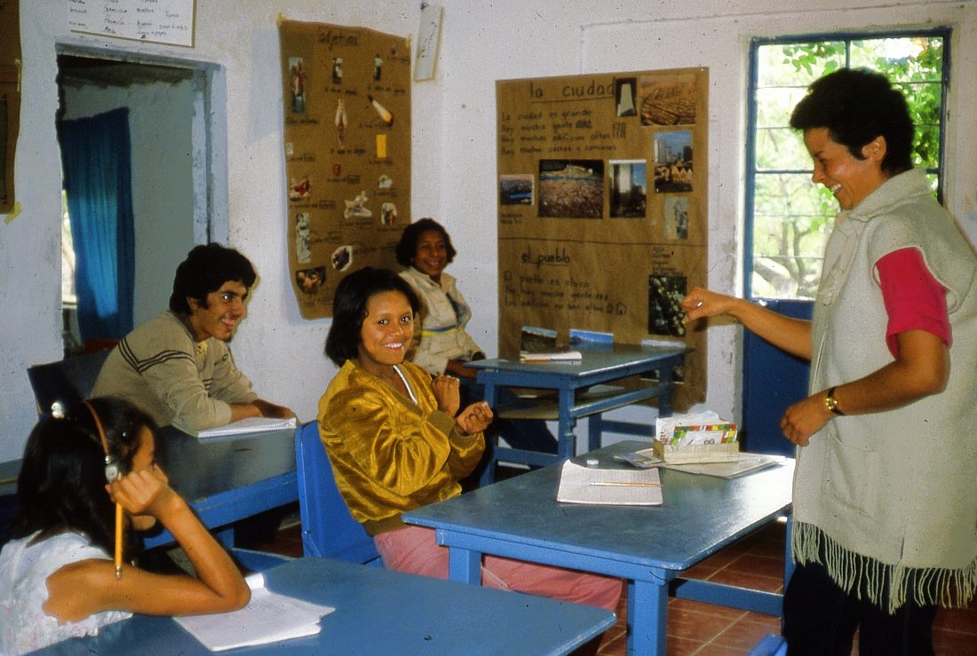 Teacher Sara uses sign language to tell her class an amusing story