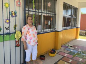 Teacher Gaby Escamilla in front of her classroom. © 2022 Noel Carmichael.