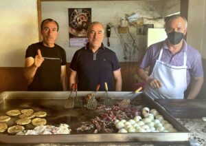 Manuel, center, and two of his brothers, manning the grill at Taqueria Maco. © 2022 Noel Carmichael.