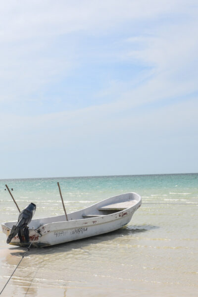 Fishing boats sit idle on the beach, Isla Holbox, Mexico © Ryan Biller, 2021