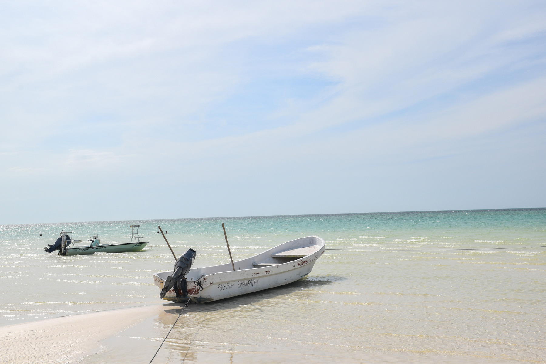 Fishing boats sit idle on the beach, Isla Holbox, Mexico © Ryan Biller, 2021