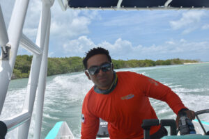 Boat captain in search of whale sharks, Isla Holbox, Mexico © Ryan Biller, 2021