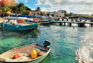 The boats from the mainland cross the Bahia de Mujeres to the downtown area where there are restaurants, shops, galleries, and golf cart rentals to navigate the island. © 2021 Jane Simon Ammeson