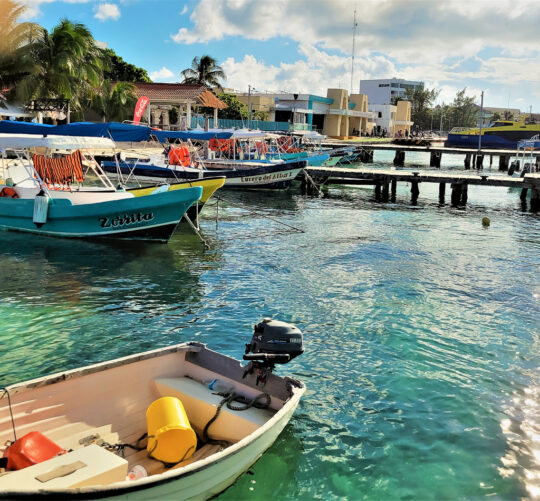 The boats from the mainland cross the Bahia de Mujeres to the downtown area where there are restaurants, shops, galleries, and golf cart rentals to navigate the island. © 2021 Jane Simon Ammeson