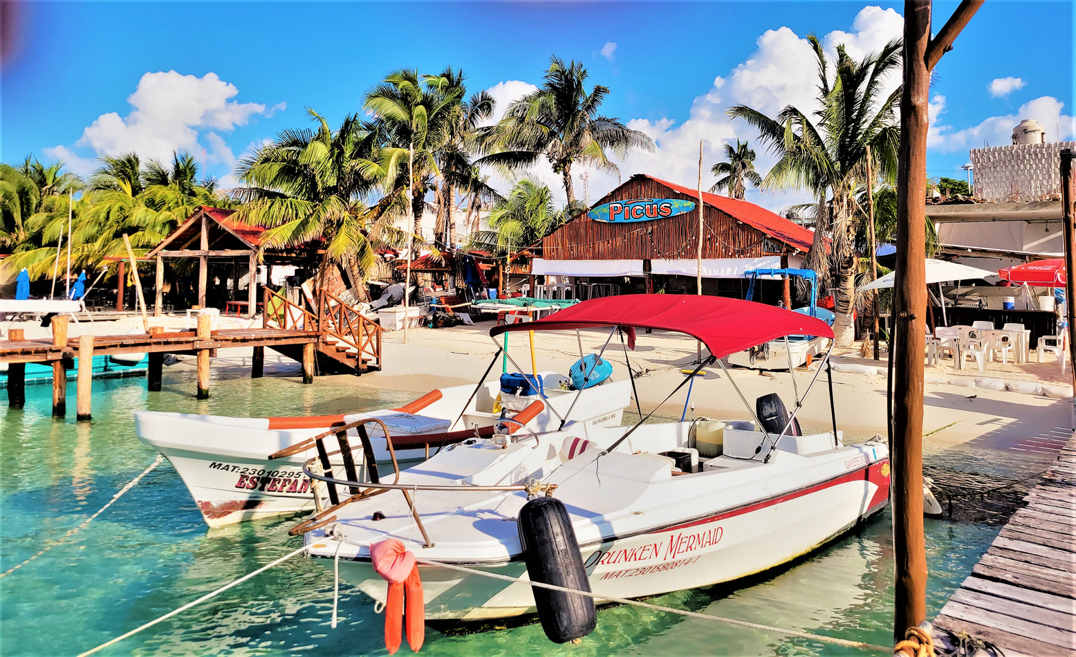 The tour boats dock at the pier in front of the Miramar Lobster House, celebrating its 50th year in business this year. © 2021 Jane Simon Ammeson