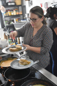 Celia Stefanoni Montagner preparing Enchiladas Formaggi e Chipotle. © Joseph Sorrentino, 2023